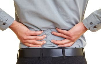 Man Grasping Back in Pain From Chiropractor Atlanta GA