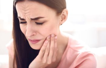 A woman suffering from dental pain.