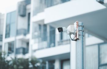 A security camera installed on the all of a residential building.